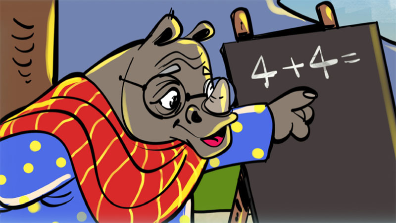 An elderly woman, depicted as a rhino, teaches math. She wears glasses and a red dupatta over a blue salwar. She is pointing to a chalk board.