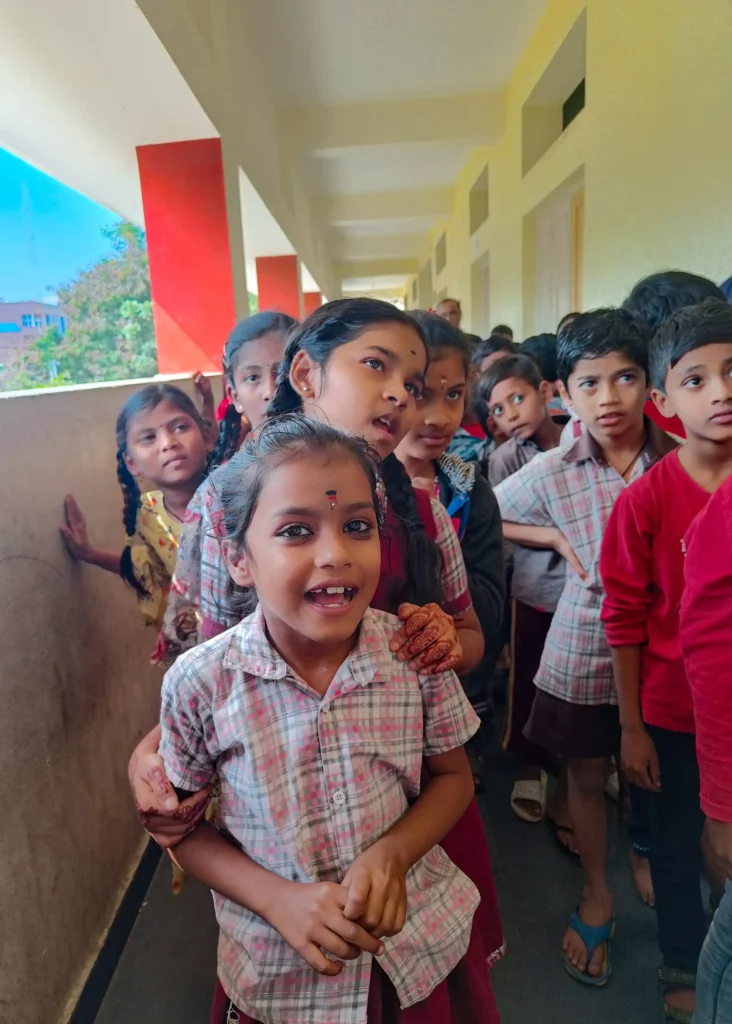 Children line up for an eye screening program at a school in India.